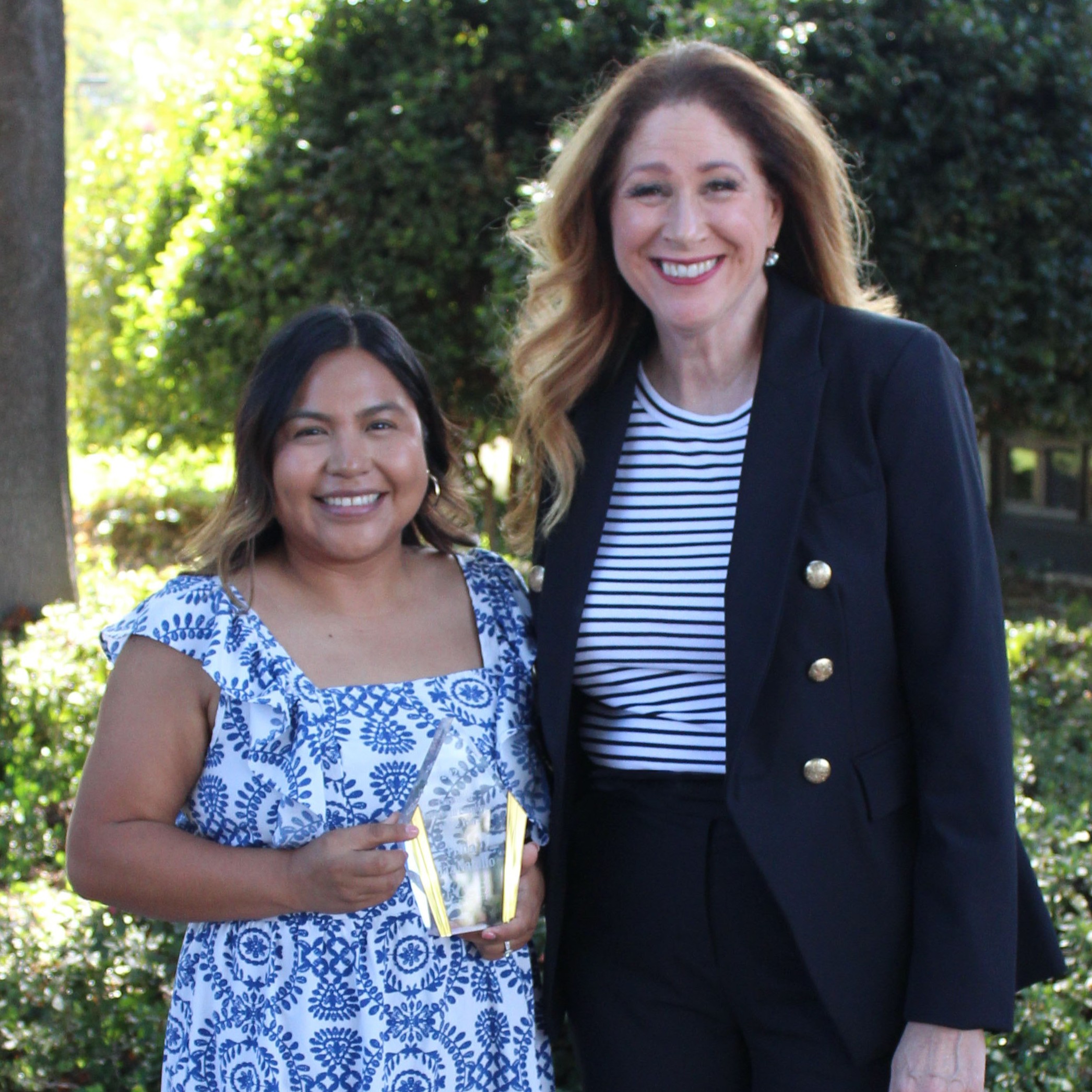 Frida Diaz Natalio  with County Suprintendent holding award