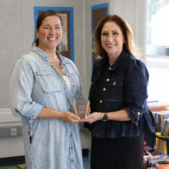Torre Ruff with County Suprintendent holding award