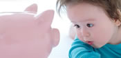 Infant with piggy bank